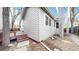 Angle shot of a well-maintained home exterior with a small deck and trees at 2266 S Kenton St, Aurora, CO 80014