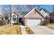 Charming home featuring a brick facade, attached garage, and well-maintained front yard at 2266 S Kenton St, Aurora, CO 80014