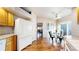 Well-lit kitchen with wood cabinets, white appliances, hardwood floors, and access to the patio at 2266 S Kenton St, Aurora, CO 80014