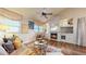 Inviting living room features hardwood floors, fireplace, and ample natural light from large windows at 2266 S Kenton St, Aurora, CO 80014