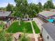 Aerial view of a fenced backyard with a green lawn, patio, and detached garage at 5115 Osceola St, Denver, CO 80212