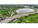 A picturesque aerial view of a lake and nearby highway, surrounded by lush greenery and a vibrant golf course at 5115 Osceola St, Denver, CO 80212