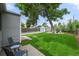 Relaxing backyard with patio, seating area, mature tree, and detached garage at 5115 Osceola St, Denver, CO 80212