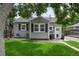 Cozy backyard featuring a well-manicured lawn, string lights, and gray siding at 5115 Osceola St, Denver, CO 80212