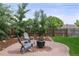 Backyard patio with fire pit, chairs, and landscaping against wood fence at 5115 Osceola St, Denver, CO 80212
