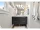 Modern bathroom featuring a dual sink vanity, bright lighting, and stylish towel racks at 5115 Osceola St, Denver, CO 80212