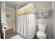Well-maintained bathroom featuring a shower with a decorative curtain and essential fixtures at 5115 Osceola St, Denver, CO 80212