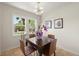Charming dining room with modern light fixture and backyard views at 5115 Osceola St, Denver, CO 80212
