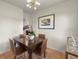 Cozy dining room features a dark wood table, seating for four and stylish lighting at 5115 Osceola St, Denver, CO 80212