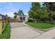 Landscaped front yard with a well-maintained lawn and a concrete driveway leading to the charming home at 5115 Osceola St, Denver, CO 80212