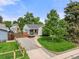 Charming home features a well-manicured lawn, lovely landscaping, and ample parking in the driveway at 5115 Osceola St, Denver, CO 80212