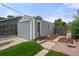 Detached garage with siding, concrete steps and partial grass and stone surroundings at 5115 Osceola St, Denver, CO 80212