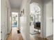 Inviting hallway showcasing hardwood floors and seamless transition into a bright and airy living room at 5115 Osceola St, Denver, CO 80212