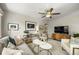 Cozy living room featuring neutral tones, modern furnishings, and a ceiling fan at 5115 Osceola St, Denver, CO 80212