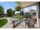 Inviting front porch with decorative metal railings, a table, and an overhead flower basket at 5115 Osceola St, Denver, CO 80212