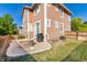 Cozy backyard featuring a stone fire pit and well-maintained lawn, perfect for outdoor gatherings at 10565 Wildhurst Cir, Highlands Ranch, CO 80126
