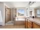 Bright bathroom featuring a tiled shower, soaking tub, and vanity with storage at 10565 Wildhurst Cir, Highlands Ranch, CO 80126