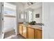 Bathroom with double sinks, vanity, and a separate tub/shower area; bright and clean at 10565 Wildhurst Cir, Highlands Ranch, CO 80126