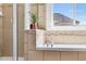 Bright bathroom featuring a soaking tub with decorative tile surround and a window at 10565 Wildhurst Cir, Highlands Ranch, CO 80126