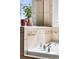 Close-up of a bathtub with decorative tiles and chrome fixtures, showcasing a stylish bathroom detail at 10565 Wildhurst Cir, Highlands Ranch, CO 80126