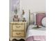 Charming bedroom detail showcasing a nightstand with gold accents, decorative lamp, and cozy bedding at 10565 Wildhurst Cir, Highlands Ranch, CO 80126