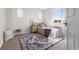 Bright bedroom with a large window, decorative rug, and a cozy, inviting atmosphere for relaxation at 10565 Wildhurst Cir, Highlands Ranch, CO 80126