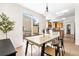 Open-concept dining area flows into the kitchen with a sleek dining table and ample natural light at 10565 Wildhurst Cir, Highlands Ranch, CO 80126