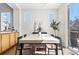 Sunlit dining area features a modern table set with stylish black chairs and plenty of natural light at 10565 Wildhurst Cir, Highlands Ranch, CO 80126