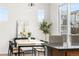 Bright dining area with contemporary table, stylish chairs, and a view of the outdoors through large glass doors at 10565 Wildhurst Cir, Highlands Ranch, CO 80126