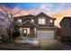 Beautiful two-story home with a two car garage at dusk at 10565 Wildhurst Cir, Highlands Ranch, CO 80126