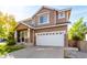 Inviting two-story house with manicured lawn, a two car garage, and nice landscaping at 10565 Wildhurst Cir, Highlands Ranch, CO 80126