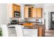 Well-lit kitchen with wooden cabinetry, a central island, and modern appliances at 10565 Wildhurst Cir, Highlands Ranch, CO 80126