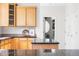 Stylish kitchen featuring a breakfast bar, granite countertops, and wooden cabinets at 10565 Wildhurst Cir, Highlands Ranch, CO 80126