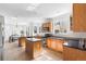 Open kitchen with a central island, tile flooring, and ample natural light at 10565 Wildhurst Cir, Highlands Ranch, CO 80126