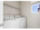 Efficient laundry room with a modern washer and dryer set, offering convenience and functionality at 10565 Wildhurst Cir, Highlands Ranch, CO 80126