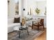 Bright living room with modern decor, a textured couch, stylish chair, and elegant rug at 10565 Wildhurst Cir, Highlands Ranch, CO 80126