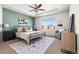 Serene main bedroom featuring a tray ceiling, large window, and designer accents at 10565 Wildhurst Cir, Highlands Ranch, CO 80126