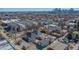 A high-angle view showcases the residence, situated within a neighborhood, and the Denver skyline at 4059 Quivas St, Denver, CO 80211