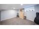 Finished basement with neutral carpet, window, and versatile space for recreation or storage at 4059 Quivas St, Denver, CO 80211