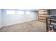 Unfinished basement with neutral carpet, window, offering ample storage or customization potential at 4059 Quivas St, Denver, CO 80211