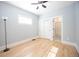 Sunlit bedroom boasts gleaming hardwood floors, fresh paint, and a ceiling fan for added comfort at 4059 Quivas St, Denver, CO 80211