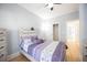 Cozy bedroom with wood floors, ceiling fan, and purple accents at 4059 Quivas St, Denver, CO 80211
