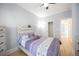 Cozy bedroom with wood floors, ceiling fan, and purple accents at 4059 Quivas St, Denver, CO 80211