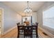 Elegant dining room with a modern chandelier, hardwood floors, and an open view to the kitchen at 4059 Quivas St, Denver, CO 80211