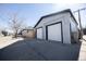 A spacious, two-car garage featuring a crisp white exterior with sleek black trim and a modern design at 4059 Quivas St, Denver, CO 80211