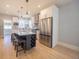Modern kitchen features a large island with seating, stainless steel appliances, and pendant lighting at 4059 Quivas St, Denver, CO 80211