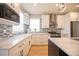 Bright kitchen with granite countertops, stainless steel appliances, and shaker cabinets at 4059 Quivas St, Denver, CO 80211