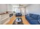 Inviting living area with hardwood floors, a sleek fireplace, and comfortable seating at 4059 Quivas St, Denver, CO 80211
