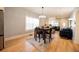 Open-concept living room featuring hardwood floors, modern lighting, and stylish furniture at 4059 Quivas St, Denver, CO 80211
