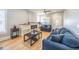 Cozy living room featuring hardwood floors, a modern fireplace, and an open floor plan at 4059 Quivas St, Denver, CO 80211